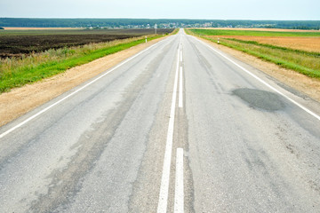 asphalt road leading to poor quality horizon asphalt needs repair