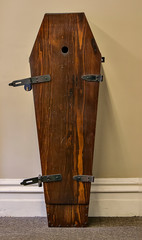 An old wooden coffin with hinges. 