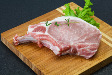 Raw pork bone steak over wooden