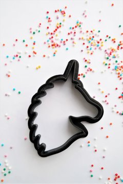 cutting for cookies in the shape of a unicorn Easter cookies