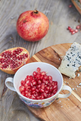 pomegranate seed salad and cheese on wooden table