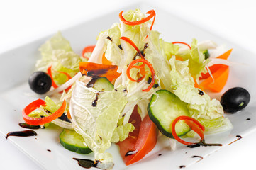 Vitamin salad with fresh vegetables on a white plate, closeup