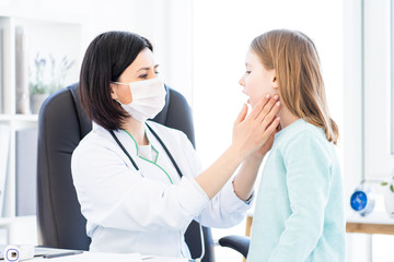 Doctor doing palpation of lymph nodes in light office