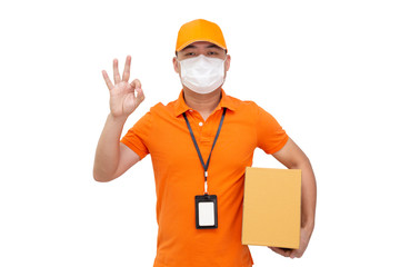 Fototapeta na wymiar Delivery man holding parcel box and wearing protective mask for prevent virus Covid-19 and showing ok isolated on white background, Online shopping shipment and fast express delivery service concept