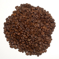 Pile of roasted coffee beans over white background