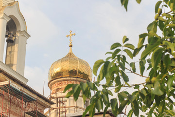 Orthodox dome with a cross on an unfinished church 