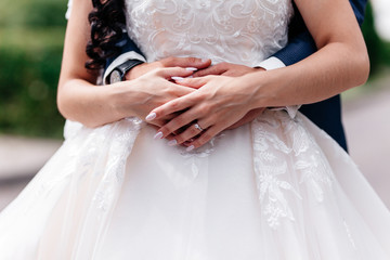 Holding hand groom and bride embracing