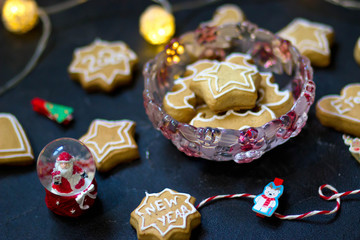 Honey gingerbread cookies on the background of a garland and Santa Claus