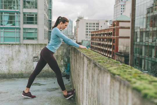 Woman stretching before exercise in the city, Vancouver, Canada