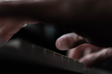 hands of a man playing the piano during the day, stylish photo