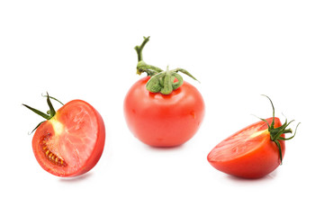 Ripe fresh organic tomato and two halves of a tomato in the drops of dew isolated on a white background	
