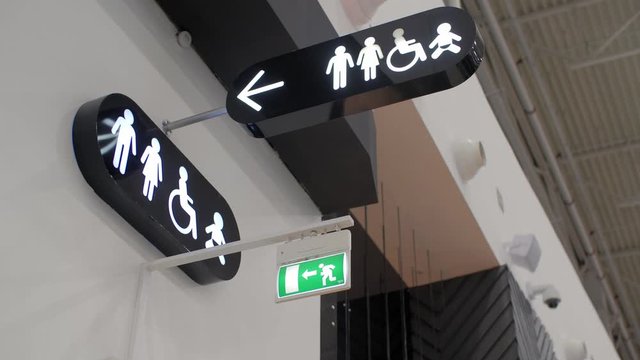 Motion of man and woman washroom logo on wall