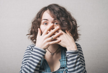 young woman covering mouth after vulgar jokes