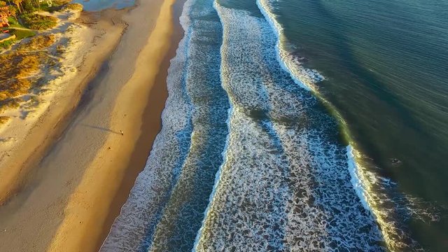 Top shot of a sandy beach and waves of the Atlantic Ocean. Spain. Tarifa