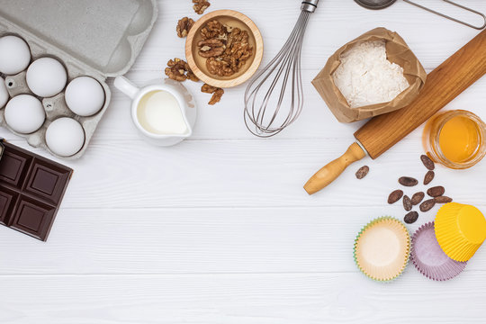 Ingredients and utensil for baking on white background,