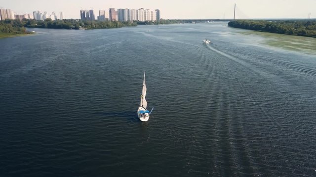 Flying around the yacht on the river Dnipro in summer. Aerial drone footage.