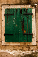 Obraz na płótnie Canvas doors, windows, locks, worn and old, of wood and painted, in picturesque houses of towns,
