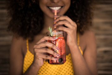 Close-up of woman drinking fresh ice tea drink