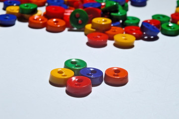 small multi-colored buttons on a white background. close-up.