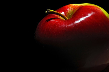 red apple on a black background