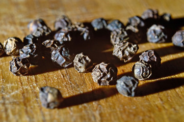 black pepper on a wooden surface. close-up.