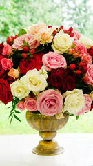 a large bouquet of roses in a vase in vintage style