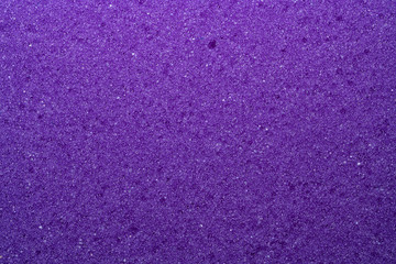 Background of foam sponge close-up. Purple.