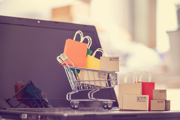 Online shopping / e-commerce and customer experience concept : Shopping cart with boxes, shopping...