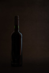 Fototapeta na wymiar Red wine bottle on rocky background