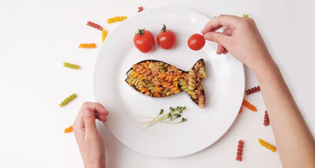Pasta in white plate decorated for baby. Kid's menu.
