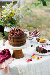 Delicious chocolate cake, red velvet in a glass, wild flowers, berries.
