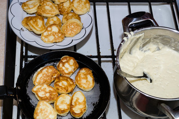 the process of making pancakes. Delicious, homemade fritters in a pan. Dough for pancakes in a pan.