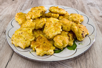 chopped chicken meatballs in a plate on a wooden table. Lazy fried meatballs.