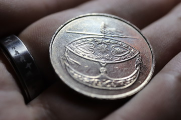 50 sen coin in hand with steel ring © Aleksander