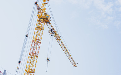 Close up of construction crane on background of blue sky.