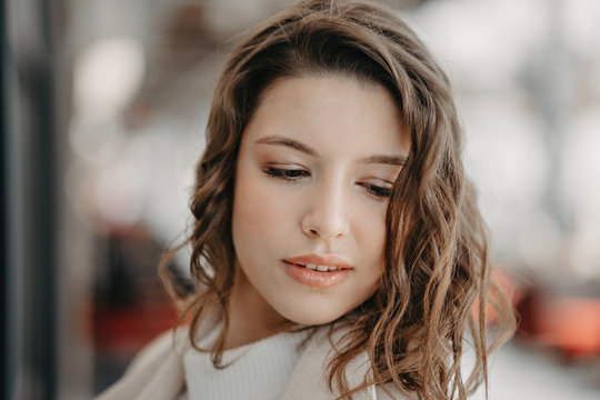 Beautiful young brunette girl close portrait looking in camera