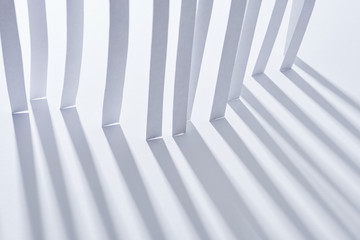 close up view of paper stripes with shadow on white background