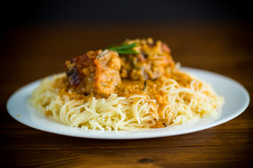 boiled vermicelli with meat and gravy in a plate