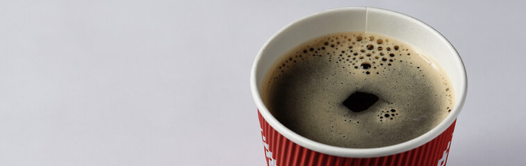 Take-out coffee in opened thermo cup against white.