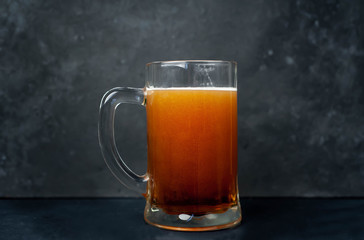 glass of beer on stone background with copy space for your text
