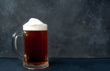 glass of beer on stone background with copy space for your text