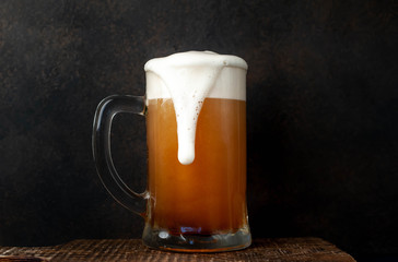 fresh beer in a beer glass on a stone background
