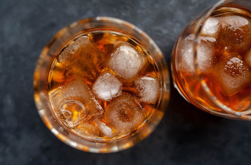 Two glasses with whiskey on a stone background .Close-up.