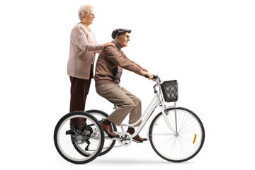 Grandparents riding on a tricycle