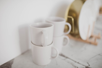 Beautiful stylish white mugs in the kitchen.