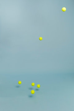 Yellow tennis balls againt blue with drop shadow