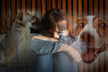 Cynophobia concept. Double exposure of scared little girl and dogs