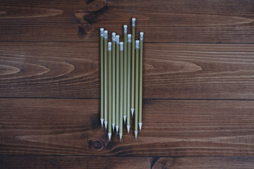 Simple pencils with an eraser on brown boards.