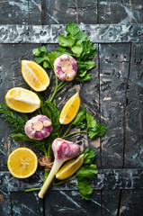 Culinary background. Parsley, garlic and lemon. Top view. Free space for your text.
