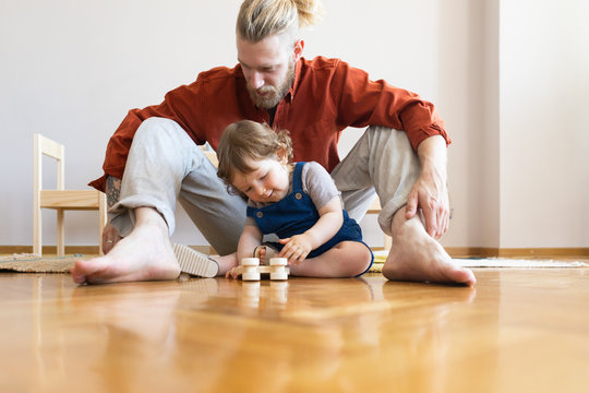 Baby and Dad Playing on the Floor